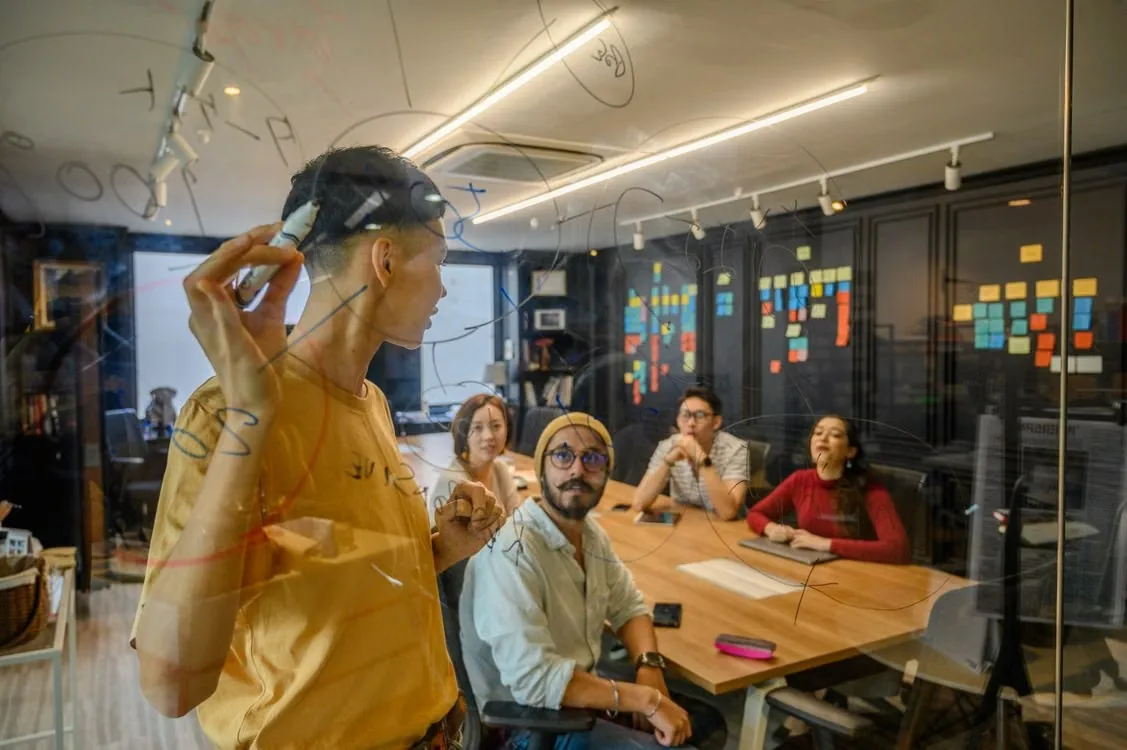 Team planning on a glass whiteboard