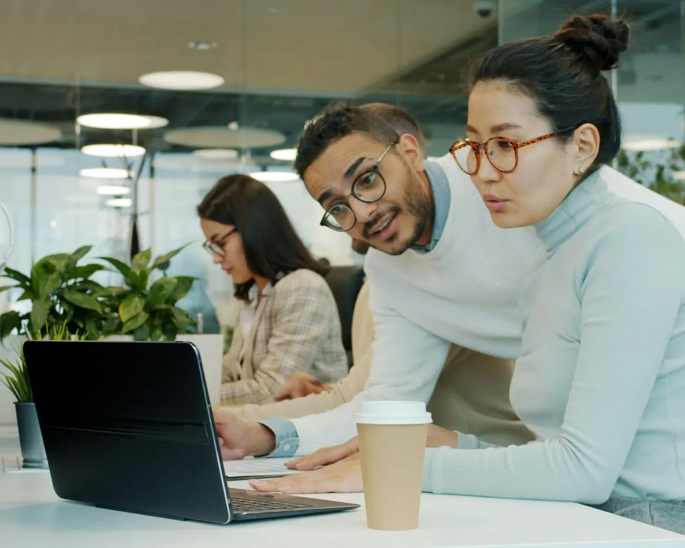 Two colleagues working at a laptop