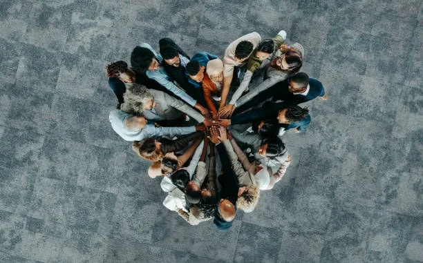 Team joining hands in a circle